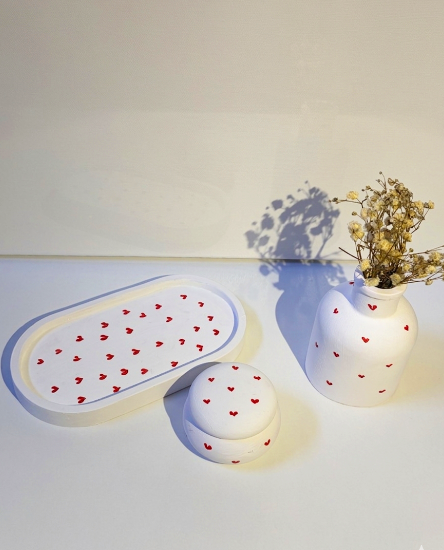RocioTreasure heart-decorated vanity tray, vase, and matching round trinket box under warm light.