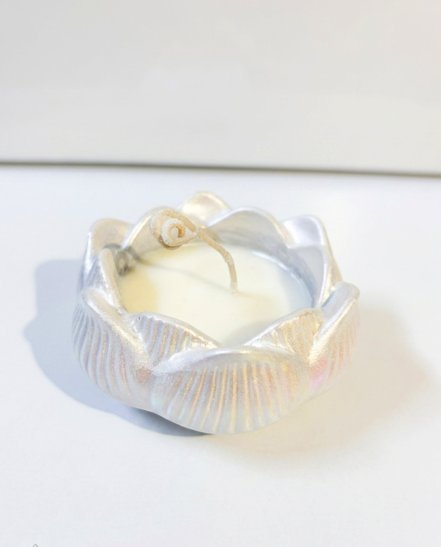 Close-up of RocioTreasure pearly lotus candle with an iridescent shimmer.